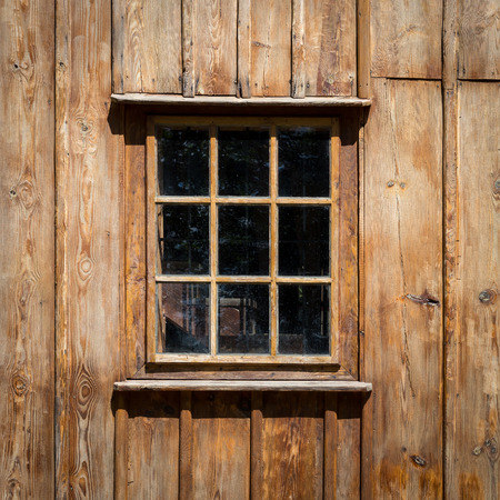 The old window of old wooden house - Background of wooden walls