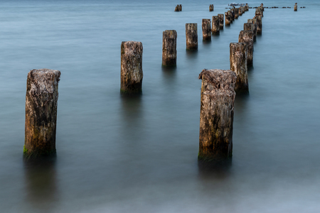 Wooden breakwaters on the sea shore.の写真素材