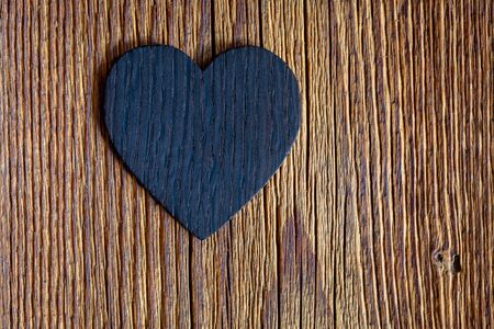 Wooden heart on old wooden background.の写真素材