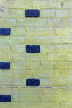 Background texture of a old yellow brick wallの写真素材