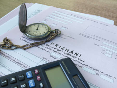 Czech republic, Prague, 25 February 2021: tax form, Czech declaration of corporation taxes. Selective focus on word "admitted" Translation: "Tax form, Pocket Watch, calculatorのeditorial素材