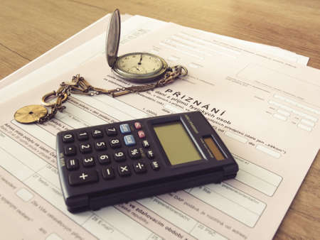 Czech republic, Prague, 25 February 2021: tax form, Czech declaration of corporation taxes. Selective focus on word "admitted" Translation: "Tax form, Pocket Watch, calculatorのeditorial素材