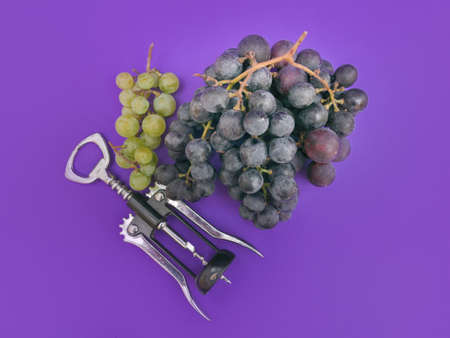 red wine and white grapes and corks on purple background, photoの写真素材