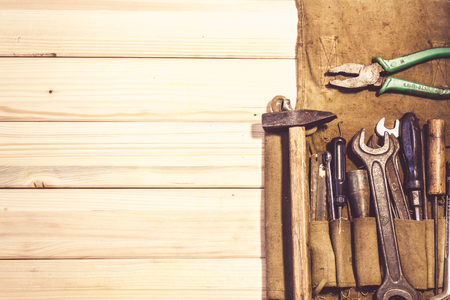 Assorted mixed work tools on woodの写真素材