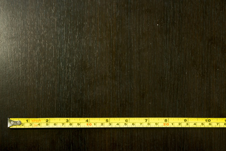Open yellow roulette meter on a dark wooden backroundの写真素材