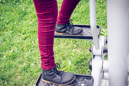 Person doing some feet exercises in a park on a fitness machineの写真素材