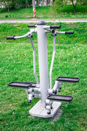 Shot made to a fitness equipment for legs exercises in a park on the grassの写真素材