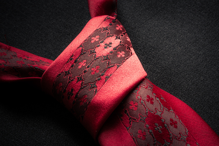 Close up of a tie knot over a business coat fabric textureの写真素材