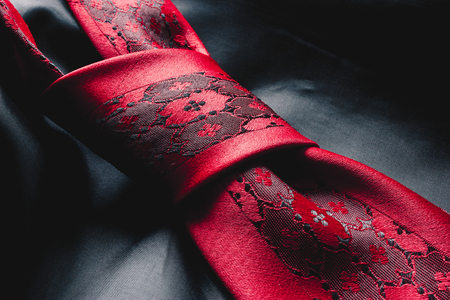 Close up of a tie knot over a silk fabric textureの写真素材
