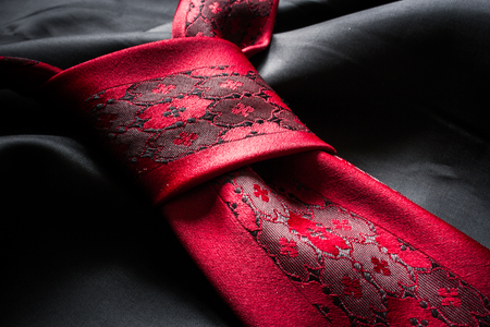 Close up of a tie knot over a silk fabric textureの写真素材