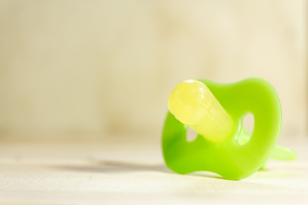 Shot of a pacifier in an yellowish backgroundの写真素材