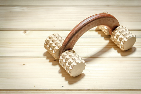 Shot of a wooden back massager on a wooden tableの写真素材