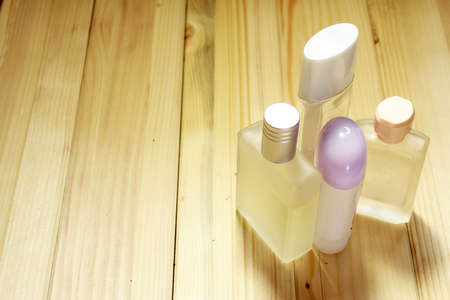A few ladies perfume bottles standing on a wooden tableの写真素材