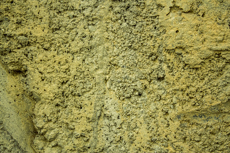 Grunge yellow wall texture made from rockの写真素材