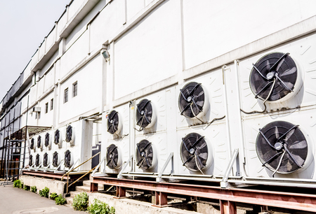 Air conditioning systems mounted on an exterior supermarket wallの写真素材