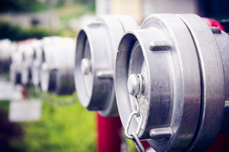 Shot of a few hydrants connectors in a parkの写真素材