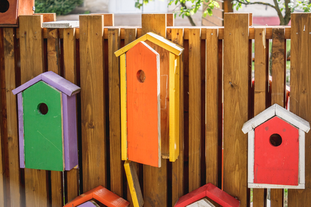 Shot to a few bird houses caught on a wooden wall made by manの写真素材