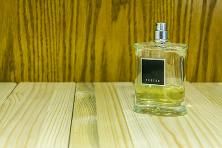 Shot to a perfume battle on a wooden background with negative spaceの写真素材