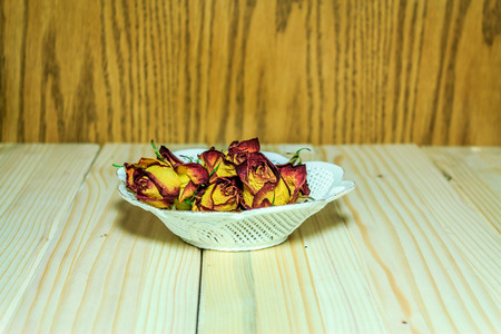 Shot to a plate full of artifficial ornamental  rosesの写真素材