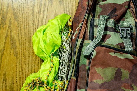 Shot to a bag prepared for hiking with wooden texture in backgroundの写真素材