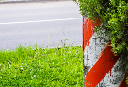 Shot to a red marked pillar on the side of a streetの写真素材