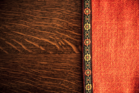 Shot to a rustic backround made from an orange rustic cloth and a dark brown wooden plank in Transilvaniaの写真素材