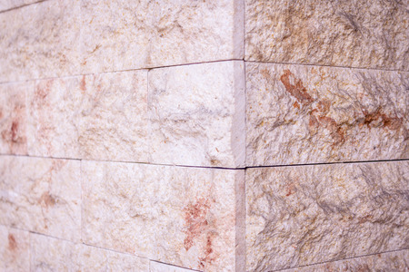 Close up shot to a rocky corner brick wall patternの写真素材