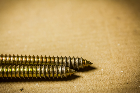 Macro shot to a couple screw threads on a cardboardの写真素材