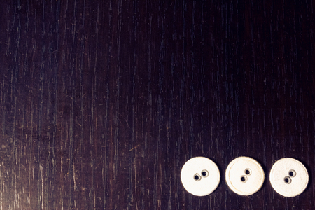 Close up shot to three white buttons on a wooden backgroundの写真素材