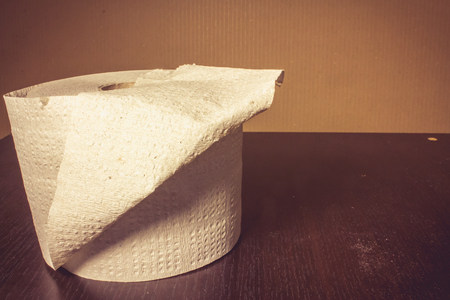 Close up shot to a toilette paper on a wooden backgroundの写真素材