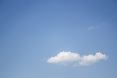 Shot to a single cloud in a selene sky in the summer timeの写真素材