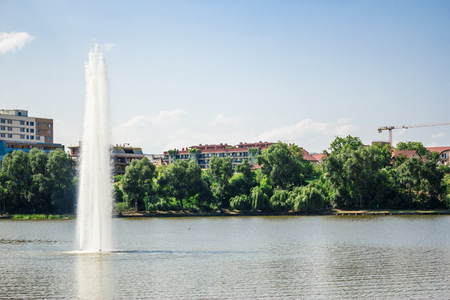Shot to a burst of water from a lake in the downtown of a city somewhere in Romaniaの写真素材