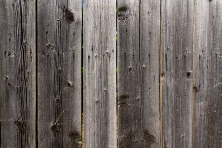 Close up shot to a textured dark wooden fenceの写真素材