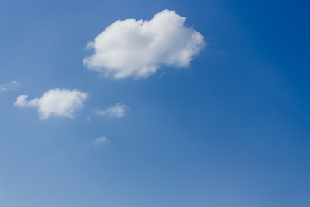 Shot to a couple of clouds in a selene sky in the summer timeの写真素材