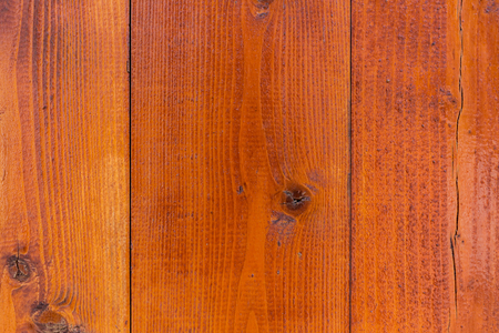 Close up shot to a textured orange wooden fenceの写真素材