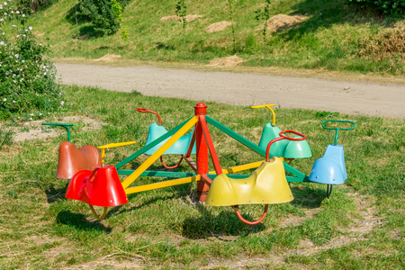 Mini carousel for kids on a playground in summer timeの写真素材