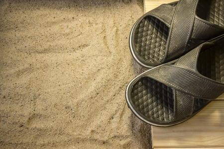 Shot to a few wooden planks, sand and a few summer clothing articlesの写真素材