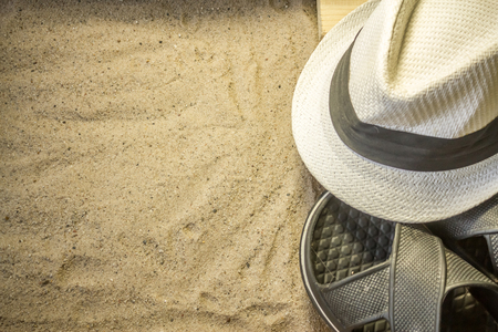 Shot to a few wooden planks, sand and a few summer clothing articlesの写真素材