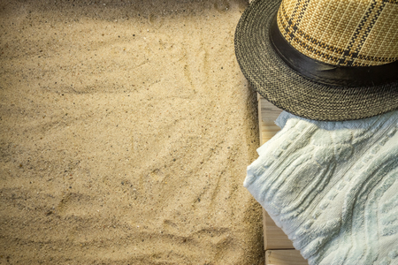 Shot to a few wooden planks, sand and a few summer clothing articlesの写真素材