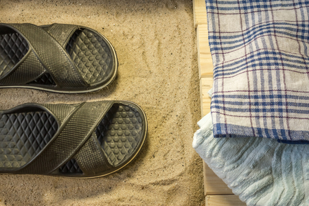 Shot to a few wooden planks, sand and a few summer clothing articlesの写真素材