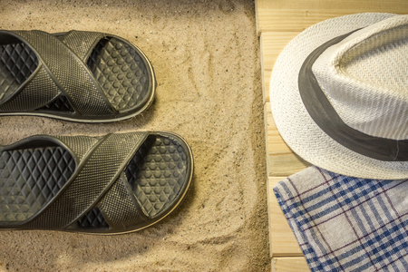 Shot to a few wooden planks, sand and a few summer clothing articlesの写真素材
