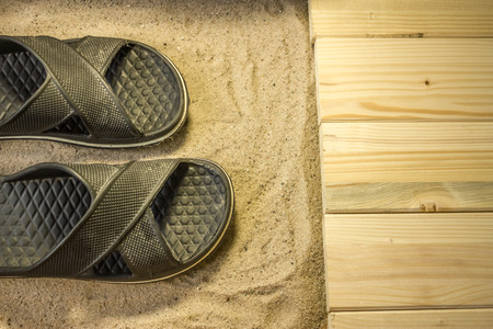 Shot to a few wooden planks, sand and a few summer clothing articlesの写真素材