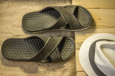 Shot to a few wooden planks, sand and a few summer clothing articlesの写真素材