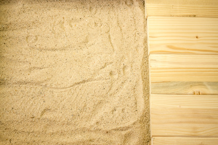 Summer beach backround made from some wooden planks and sandの写真素材
