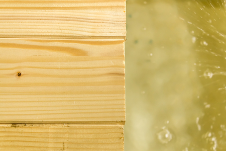 Close up shot to a few wooden planks and a few water splashesの写真素材