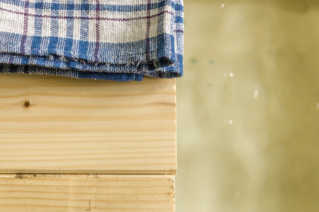 Close up shot to a towel standing on a wooden floor next to waterの写真素材