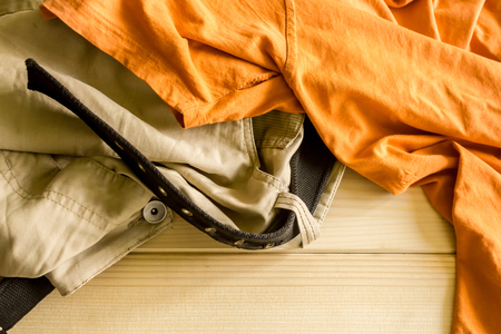 Close up shot to a few crumpled clothes on a wooden backgroundの写真素材