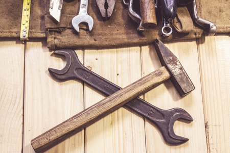 Assorted mixed work tools on woodの写真素材