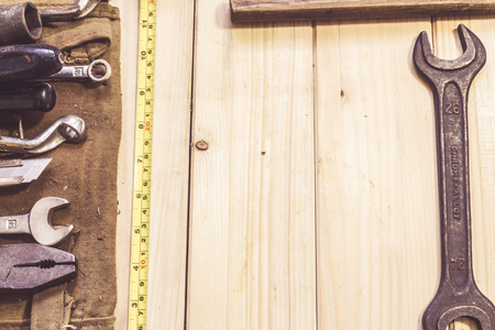 Assorted mixed work tools on woodの写真素材