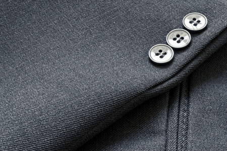 Close up of a few buttons on a business suit coatの写真素材
